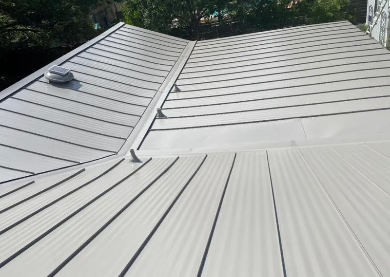 Solar attic fan installed on a metal roof for Roof Ventilation in Garden City