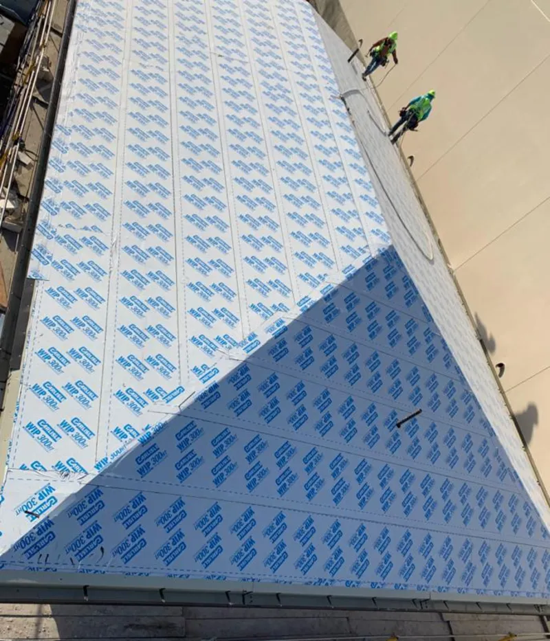 Professional roofers installing underlayment on a metal roof in Garden City